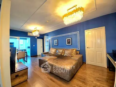 Luxurious living room with elegant chandeliers and plush leather sofa in modern apartment.