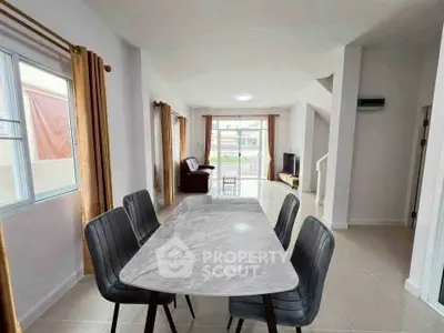 Spacious modern living room with dining area and natural light