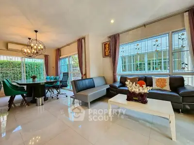 Spacious modern living room with elegant decor and large windows for natural light.