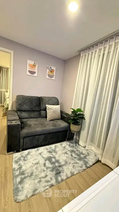 Cozy living room with plush sofa and modern decor, perfect for relaxation.