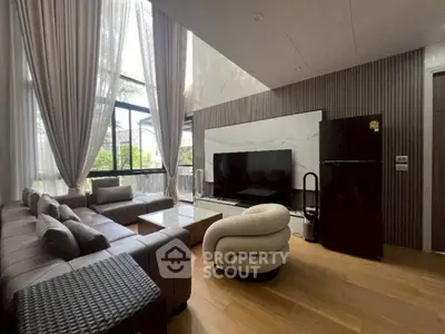 Luxurious living room with modern furniture and large windows