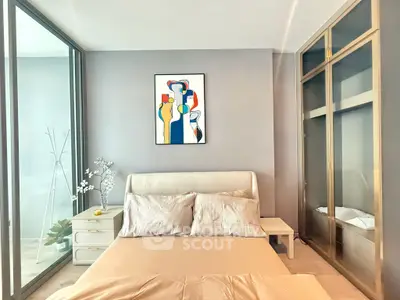 Modern bedroom with stylish decor and large glass wardrobe, perfect for urban living.