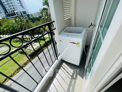 Charming balcony with washing machine and scenic view in modern apartment