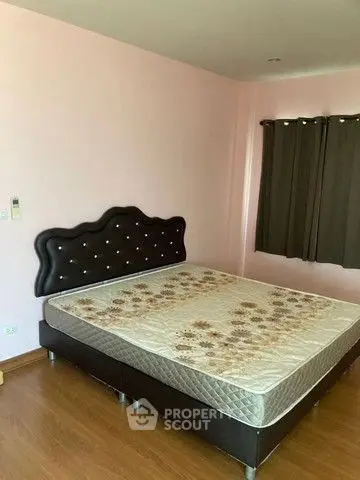 Cozy bedroom with stylish headboard and wooden flooring