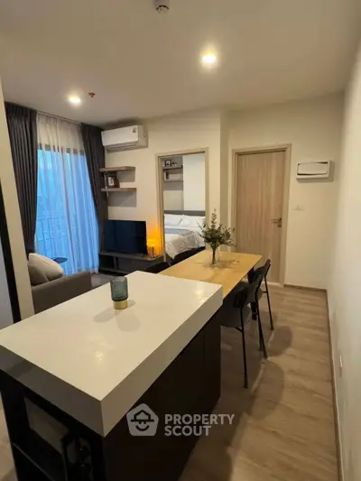Modern open-plan living room with dining area and stylish decor in a cozy apartment.