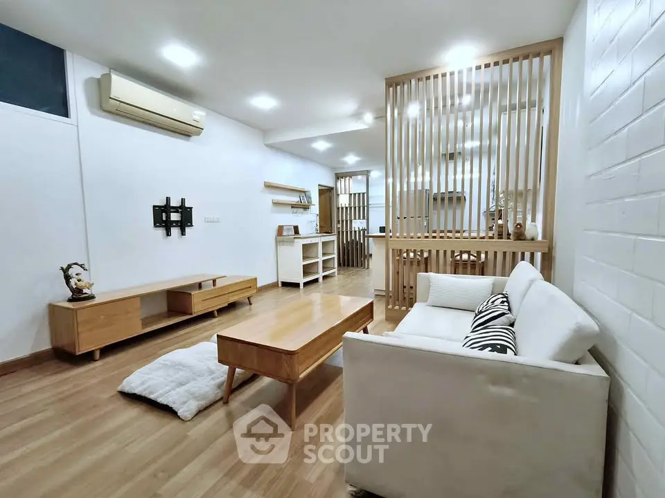 Modern living room with wooden flooring and stylish furniture