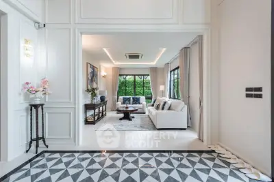 Luxurious living room with elegant decor and large windows offering a serene garden view.