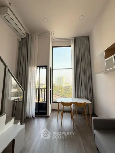 Modern high-ceiling living room with large windows and city view