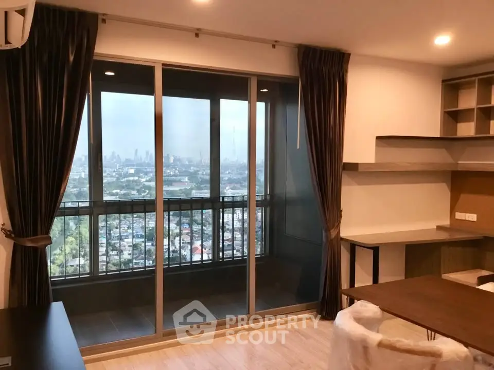 Modern living room with city view from large balcony, featuring stylish furniture and elegant decor.