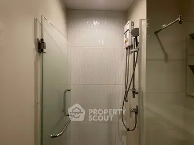 Modern bathroom with glass shower enclosure and sleek fixtures