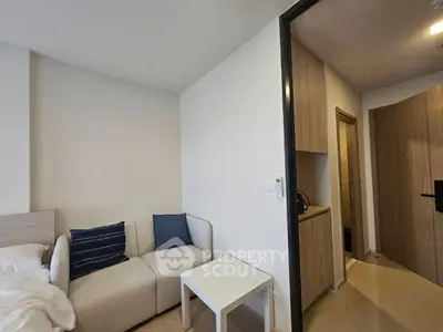 Modern studio apartment with cozy living area and compact kitchen