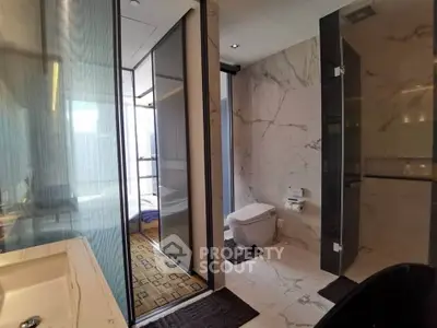 Luxurious modern bathroom with marble walls and sleek fixtures in a high-end apartment.