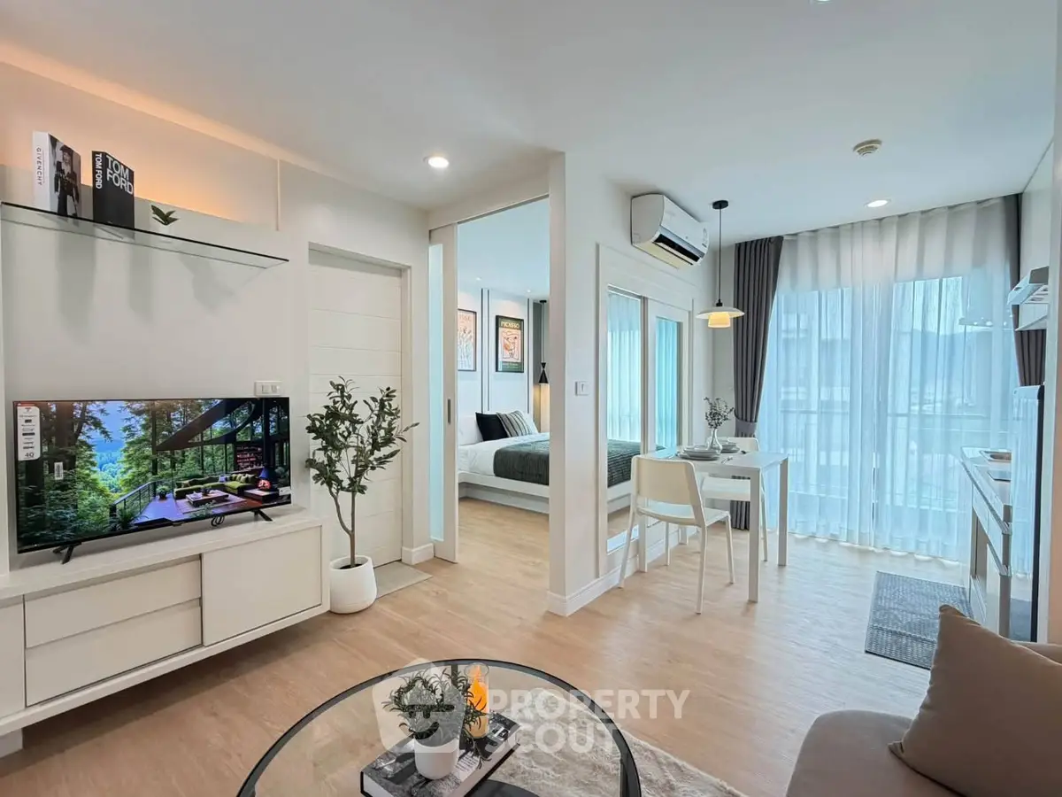 Modern open-plan living room with stylish decor and natural light in a contemporary apartment.