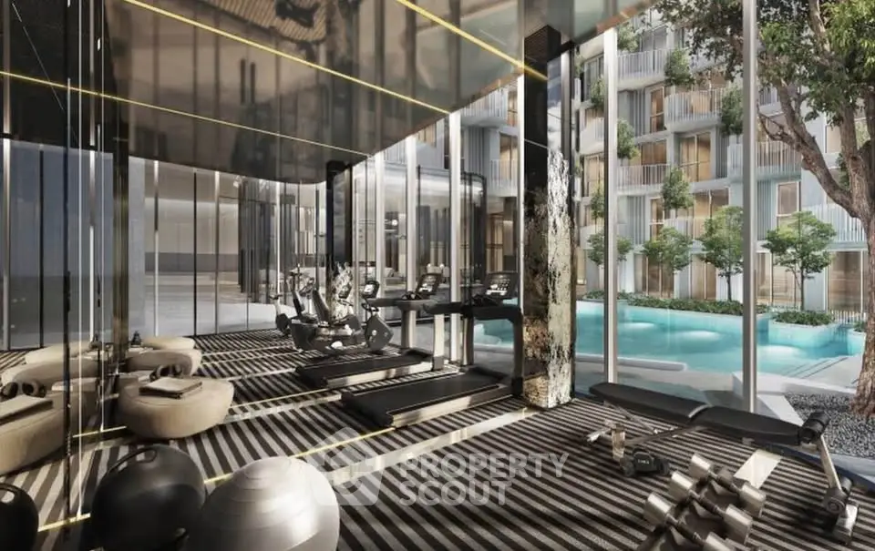 Luxurious gym with modern equipment and pool view in upscale residential complex.
