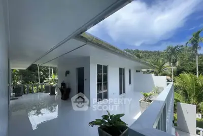 Stunning modern balcony with lush greenery and mountain views, perfect for relaxation and outdoor enjoyment.