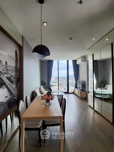 Stylish living room with city view, modern decor, and elegant dining area.