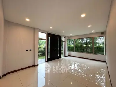Spacious living room with large windows and garden view