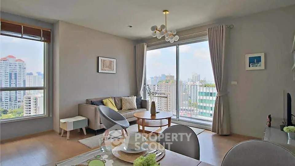Modern living room with city view, stylish decor, and natural light.