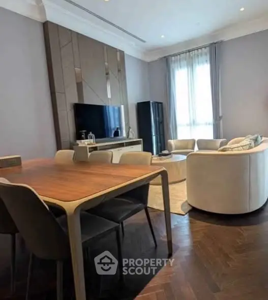 Elegant living room with modern furniture and large window, perfect for stylish urban living.