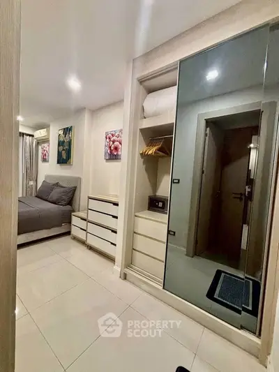 Modern bedroom with sleek wardrobe and cozy bed in stylish apartment.