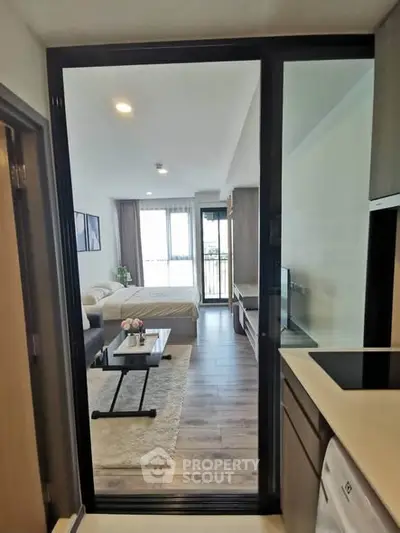 Modern studio apartment with open layout and stylish furnishings, featuring a cozy living area and a bright bedroom.