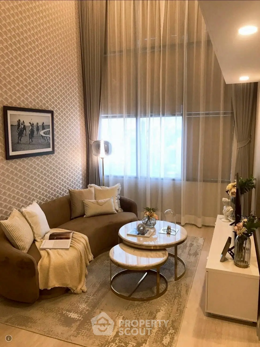 Elegant living room with high ceilings, modern decor, and cozy seating area.