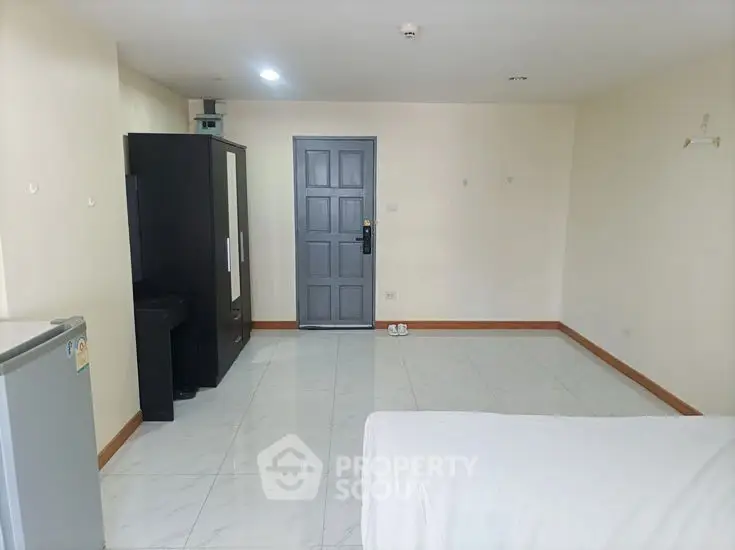 Spacious minimalist bedroom with wardrobe and modern decor