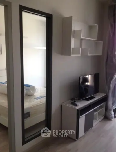 Modern living room with sleek TV stand and wall-mounted shelves