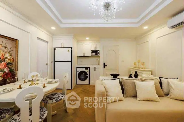 Elegant living room with open kitchen, featuring modern appliances and chic decor.
