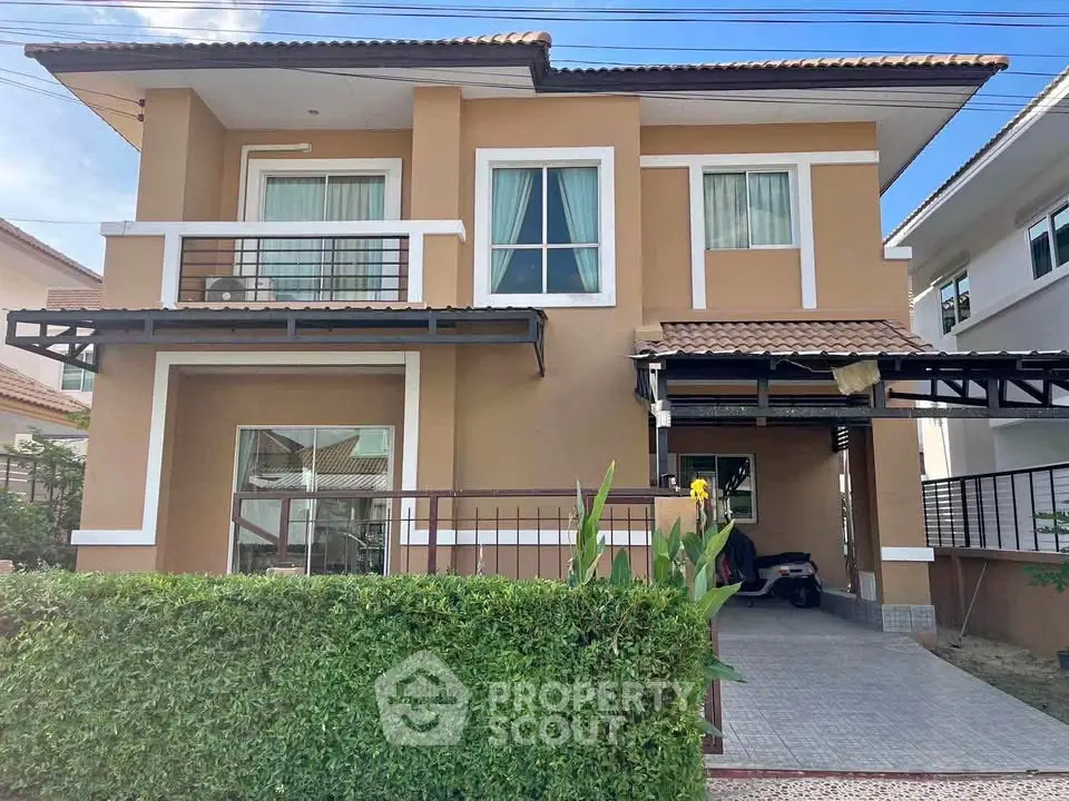 Charming two-story house with modern design and lush greenery, perfect for family living.