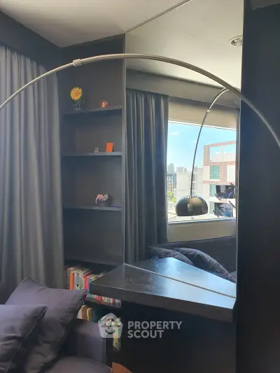 Modern living room with stylish bookshelf and city view, perfect for urban living.