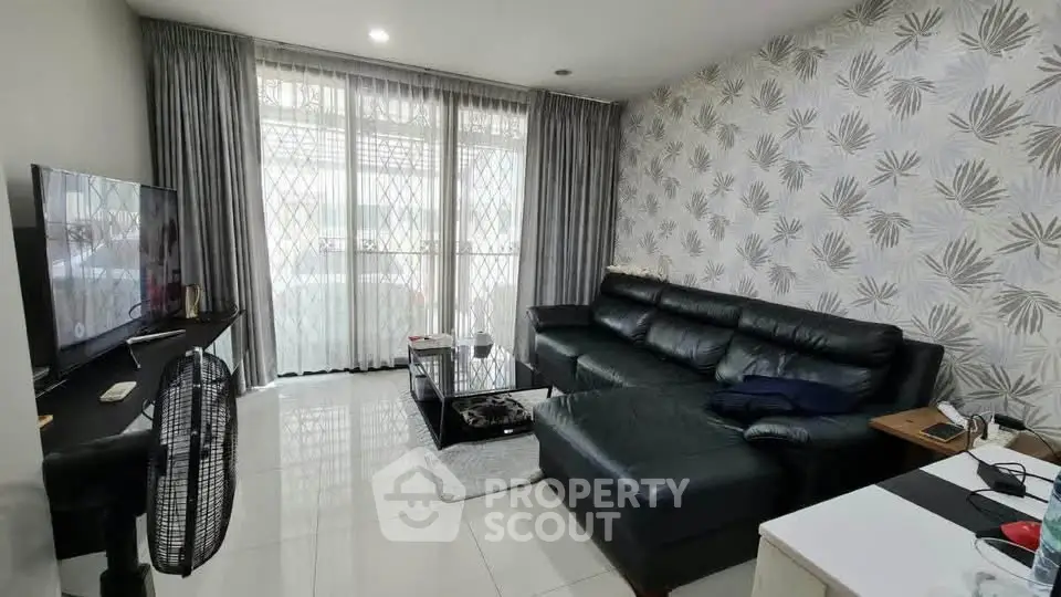 Spacious living room with modern decor and large windows for natural light.