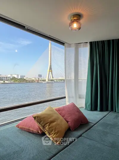 Stunning river view from modern living room with cozy seating and large windows