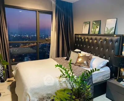 Luxurious bedroom with stunning city view, elegant decor, and cozy ambiance perfect for relaxation.