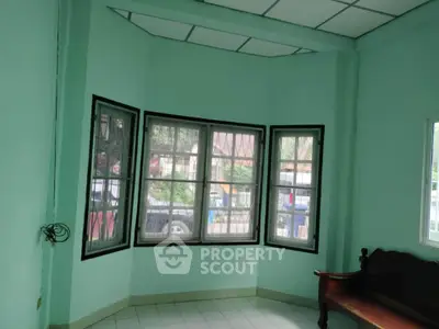 Spacious room with large windows offering ample natural light and a view of the outdoors.