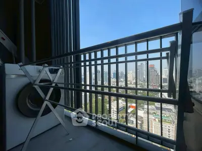 High-rise balcony with city view and washing machine, perfect for urban living.