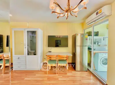 Charming living area with dining set, TV, and modern appliances in a cozy apartment.