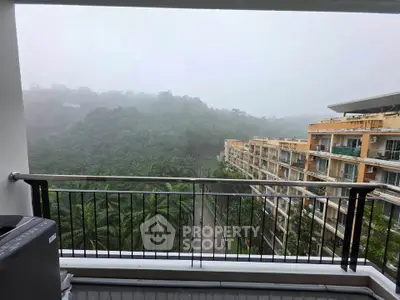 Stunning balcony view overlooking lush greenery and modern apartment complex, perfect for nature lovers.