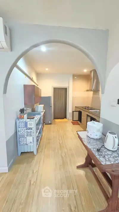 Spacious kitchen with modern appliances and open layout, perfect for culinary enthusiasts.