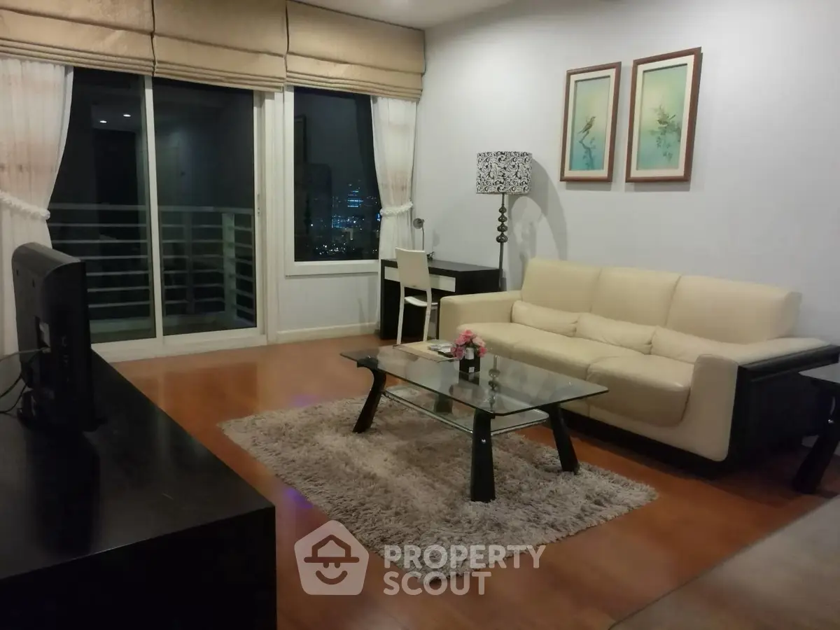 Elegant living room with city view, featuring modern furniture and stylish decor.