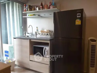 Compact kitchen with modern appliances and sleek design