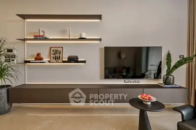 Modern living room with sleek wall-mounted TV and illuminated shelves, stylish decor and elegant furniture.