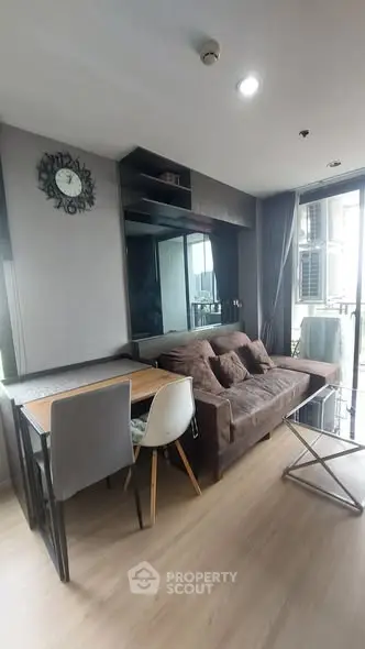 Modern living room with stylish decor and balcony access