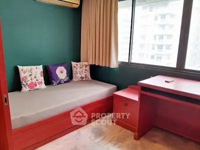Cozy study room with vibrant red furniture and large window view
