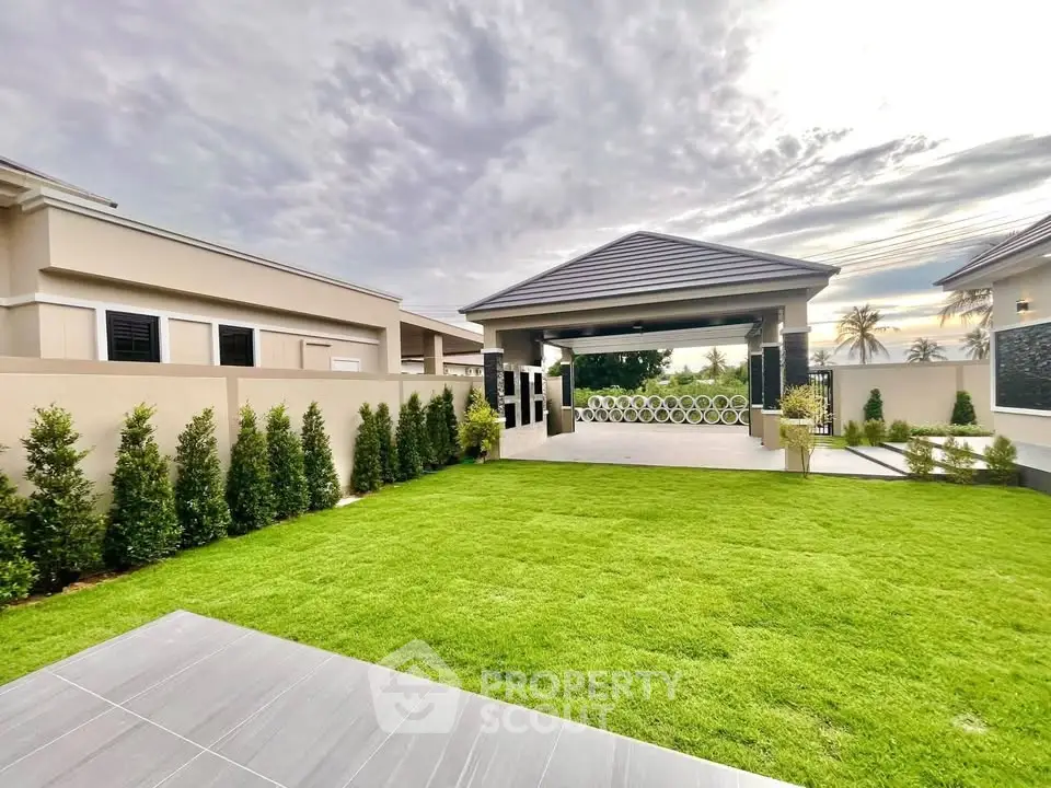 Luxurious modern home with expansive green lawn and stylish entrance