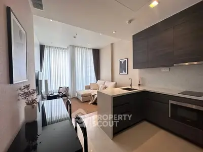 Modern open-plan living room and kitchen with sleek design and natural light.