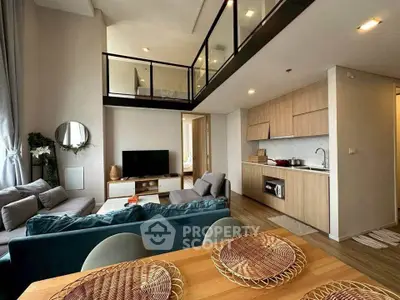 Modern loft-style living room with open kitchen and high ceilings