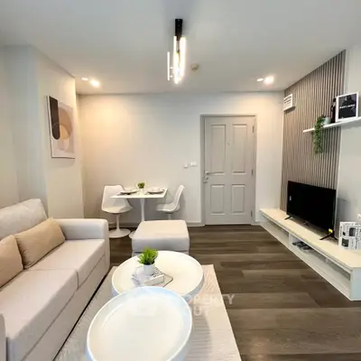 Modern living room with stylish decor and cozy seating area in a contemporary apartment.