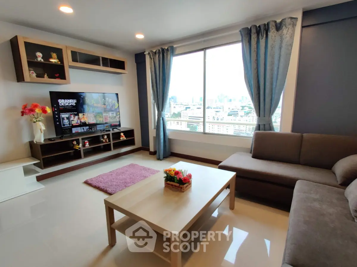 Modern living room with city view, stylish decor, and entertainment setup.