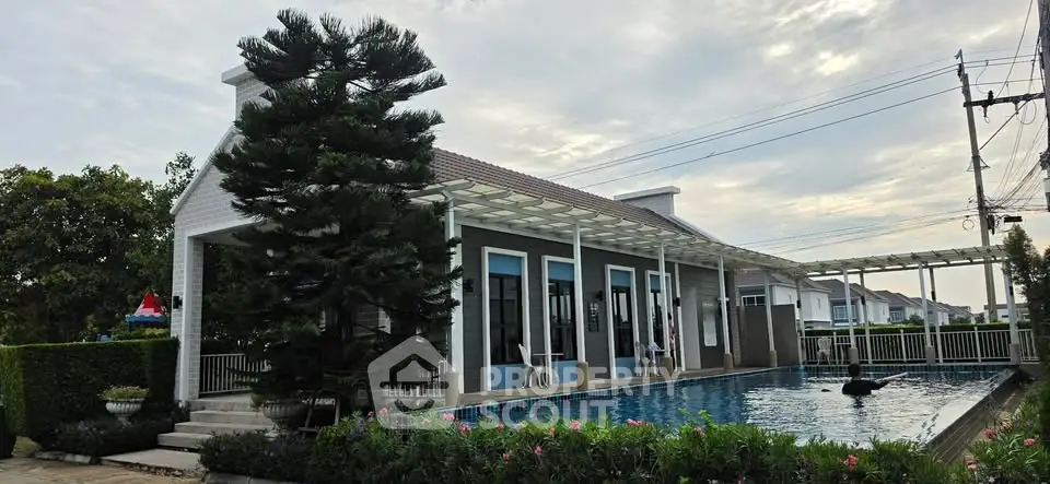 Charming residential property with a serene poolside view and lush greenery, perfect for relaxation and leisure.
